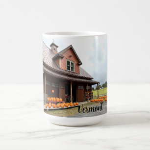 Pumpkins by a small farm building coffee mug