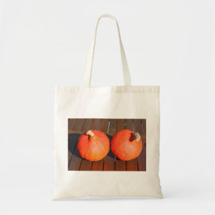 Pumpkins on a wooden table tote bag