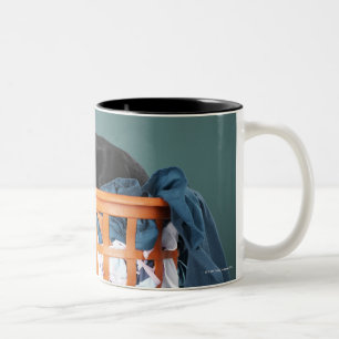 Puppy lying in laundry basket Two-Tone coffee mug