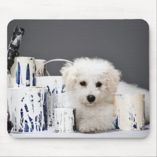 Puppy sitting amongst paint tins mouse pad