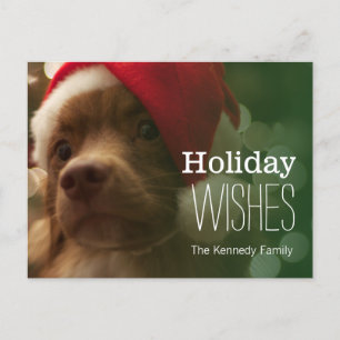 puppy sitting in front of christmas tree bokeh holiday postcard