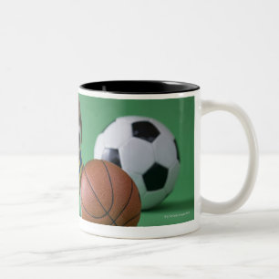 Puppy surrounded by sport balls Two-Tone coffee mug