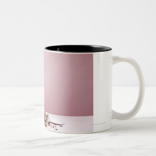 Puppy with cake on floor Two-Tone coffee mug