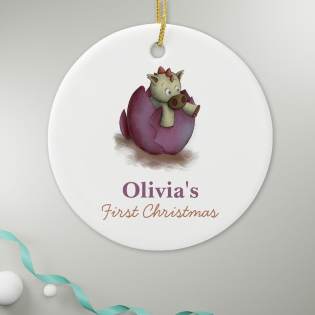 Purple Dinosaur Hatching Baby Girl First Christmas Ceramic Ornament (Baby girl first christmas ornament with a dinosaur hatching illustration)