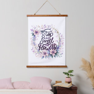 Purple floral stop and smell the flowers hanging tapestry