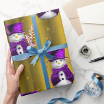 Purple Snowmen on Gold Christmas Wrapping Paper<br><div class="desc">A cute and colourful gold Christmas wrapping paper featuring a pattern of little snowmen dressed in purple velvet top hats and vests,  surrounded by gold stars to give your gift wrapping this holiday season a whimsical and stylish touch.</div>