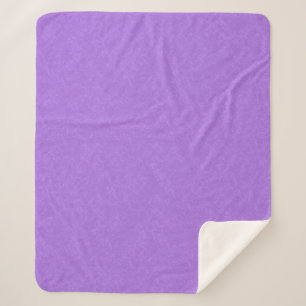 Purple textured surface with swirling pattern sherpa blanket
