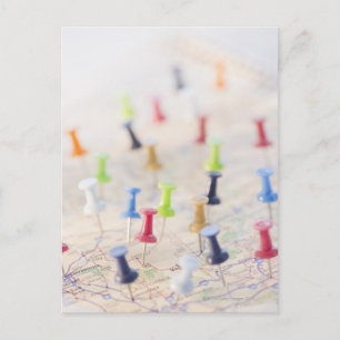 Pushpins in a map postcard