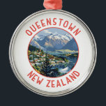 Queenstown New Zealand Retro Distressed Circle Metal Ornament<br><div class="desc">Queenstown retro vector travel design. It sits on the shores of the South Island’s Lake Wakatipu,  set against the dramatic Southern Alps.</div>