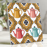 Quirky 1950s Kitsch Design with Playful Teapots Ceramic Tile<br><div class="desc">Add a touch of retro charm to your space with this quirky 1950s-inspired kitsch tile. Featuring playful teapots in coral red, mustard yellow, and turquoise, framed by atomic boomerangs and funky black and white floral accents, this tile exudes fun and nostalgia. Perfect for creating unique backsplashes, accent walls, or vintage-inspired...</div>
