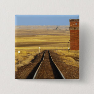 Railroad tracks lead to old granary at Collins 15 Cm Square Badge