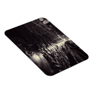 Rain water flowing on a cobblestone street magnet