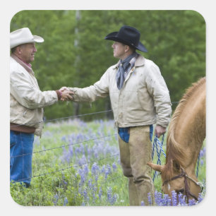 Ranchers shaking hands across the fencing in square sticker