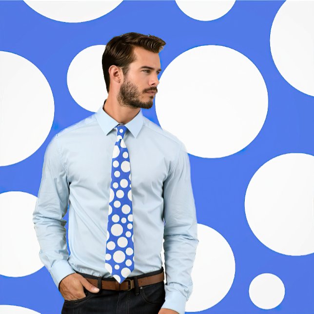 Random White Polka Dot Pattern on Royal Blue Tie (Man wears a royal blue tie featuring white polka dots of varying sizes. Background matches tie.)