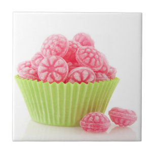 Raspberry tasty candy sweets in green cup cake ceramic tile