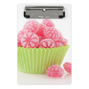 Raspberry tasty candy sweets in green cup cake mini clipboard
