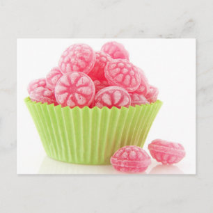 Raspberry tasty candy sweets in green cup cake postcard