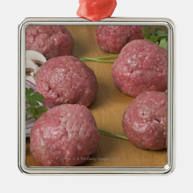 Raw meatballs on a cutting board metal ornament (Front)