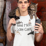 Real Men Love Cats T-Shirt<br><div class="desc">This design was created though digital art. You may change the style of this shirt by choosing More > under the style option. It may be personalised by clicking the customise button and changing the colour, adding a name, initials or your favourite words. Contact me at colorflowcreations@gmail.com if you with...</div>