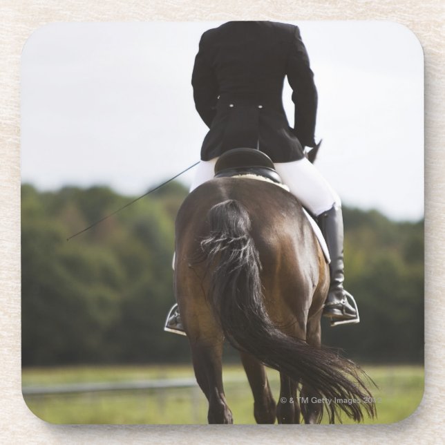 rear view of female dressage rider exercising coaster (Front)