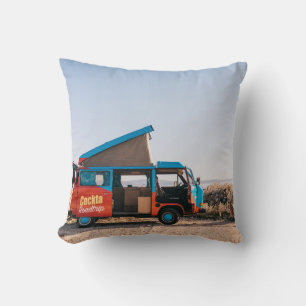 Red and blue vehicle beside man cushion