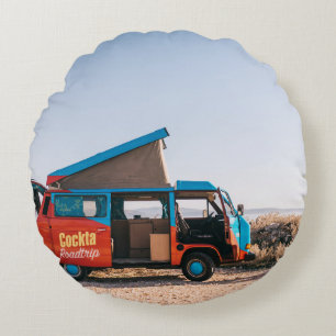 Red and blue vehicle beside man round cushion