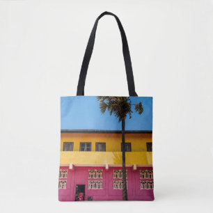 RED AND BROWN CONCRETE BUILDING NEAR TREE UNDER BL TOTE BAG