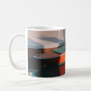 RED AND GREEN BOAT DOCKING ON DOCK COFFEE MUG