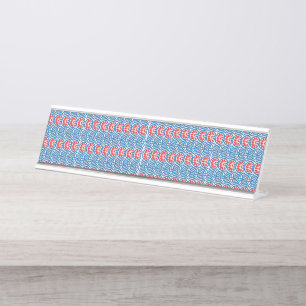 Red and orange paint swirls together, creating a v desk name plate