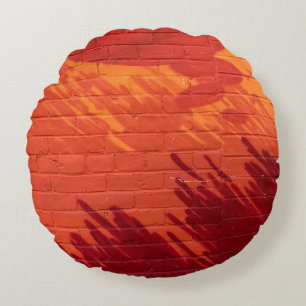 Red and orange painted brick wall round cushion