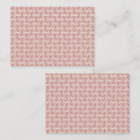 Red and pink textiles laid over a patterned rug wi
