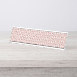 Red and pink textiles laid over a patterned rug wi desk name plate
