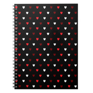 Red and white hearts on black notebook