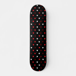 Red and white hearts on black skateboard