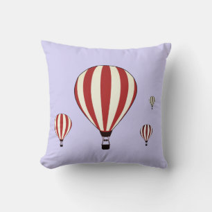 Red and white hot air balloons on periwinkle cushion