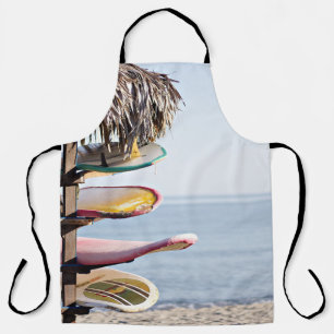 Red and white surfboard in brown wooden rack apron