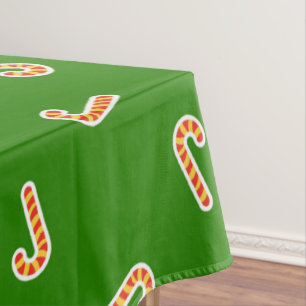 Red and yellow candy canes green tablecloth