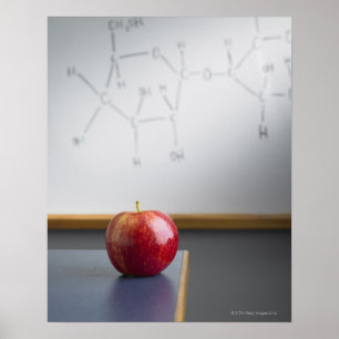 Red apple sitting on teachers desk poster