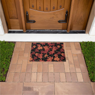 Red Autumn maple leaves on black Doormat