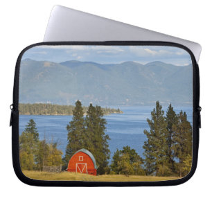 Red barn sits along scenic Flathead Lake near Laptop Sleeve