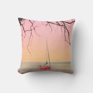 RED BOAT ON BEACH DURING SUNSET CUSHION