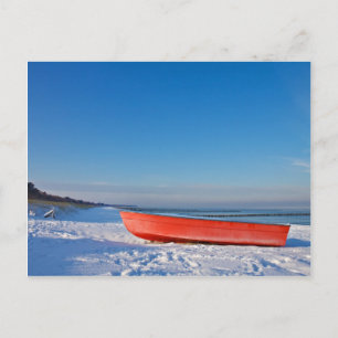 Red boat on shore of the Baltic sea in winter Postcard