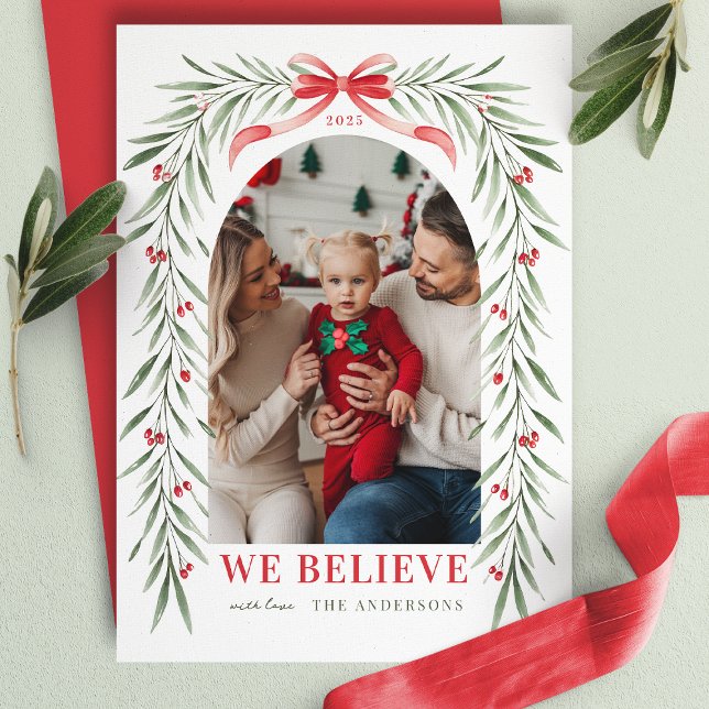 Red Bow Greenery Arch We Believe Christmas Photo  Holiday Card (Creator Uploaded)