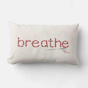 red Breathe text stitch with needle Lumbar Cushion