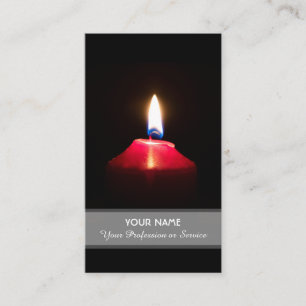 Red candle light illuminates the dark business card