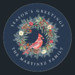 Red Cardinal Pine Wreath Season's Greetings Classic Round Sticker<br><div class="desc">Add a special touch to your envelopes or gift giving. Designed to coordinated with the Elegant Christmas Wreath and Cardinal collection. A red cardinal is nestled in a traditional pine wreath decorated with berries,  pinecones and flowers. Greeting is written above and your name below.</div>