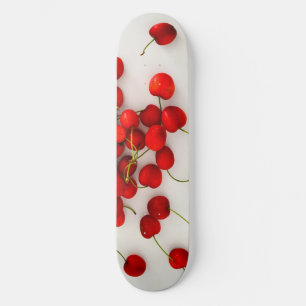 Red Cherries in Natural Light Lay on White Skateboard