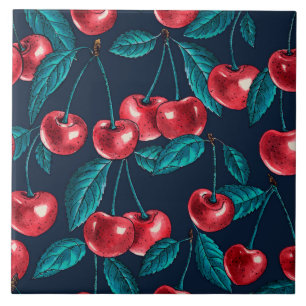 Red cherries on dark blue ceramic tile