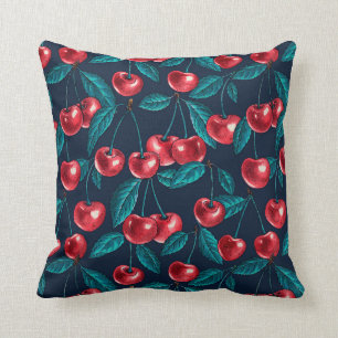 Red cherries on dark blue cushion