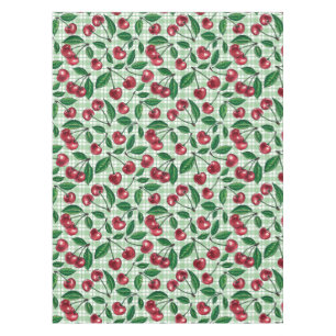 Red cherries on light green gingham tablecloth
